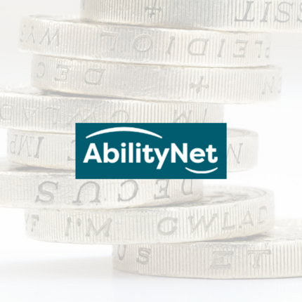 Ability Net logo in front of a stack of pound coins. 
