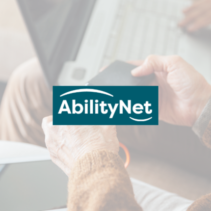 Ability Net logo in front of picture of people using technology