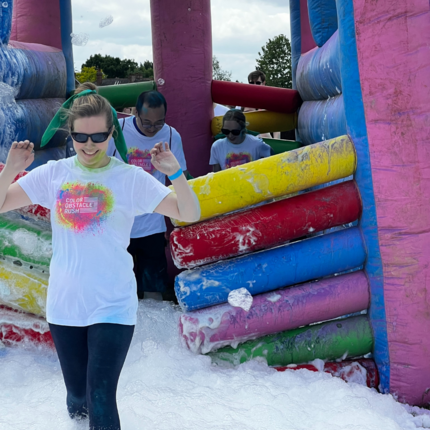 Runners running through bubbles and inflatables