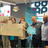 Jo Maye of KCN being presented with a huge cheque by staff at the Co-op