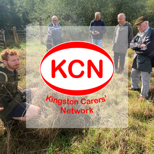 Group of men in the middle of a scything demonstration